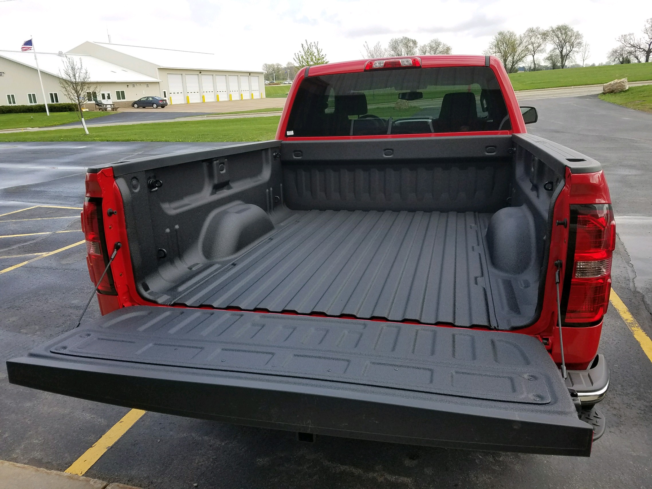 Fleet truck receiving a sprayed polyurea bed liner and underbody coating